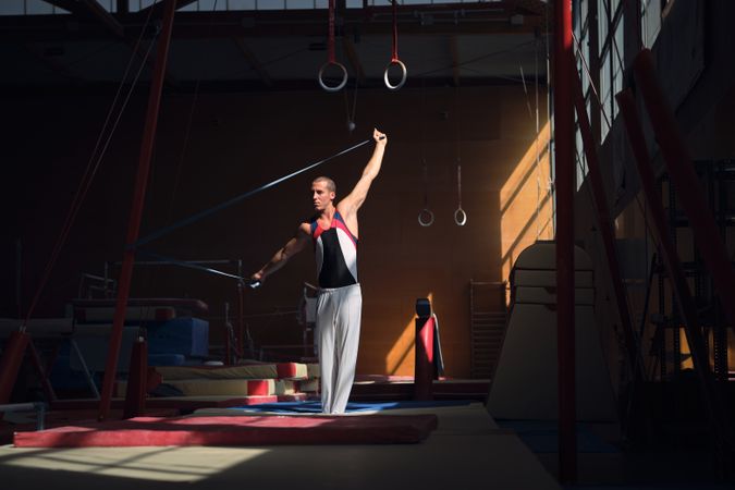 Young sports gymnast stretching with a rubber band in the gymnas
