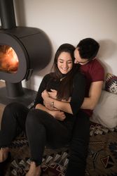 Couple sitting near fireplace on floor