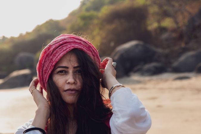 Woman wearing pink head piece at the beach