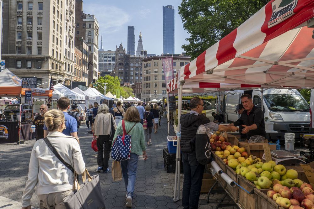 People walking through a farmers market