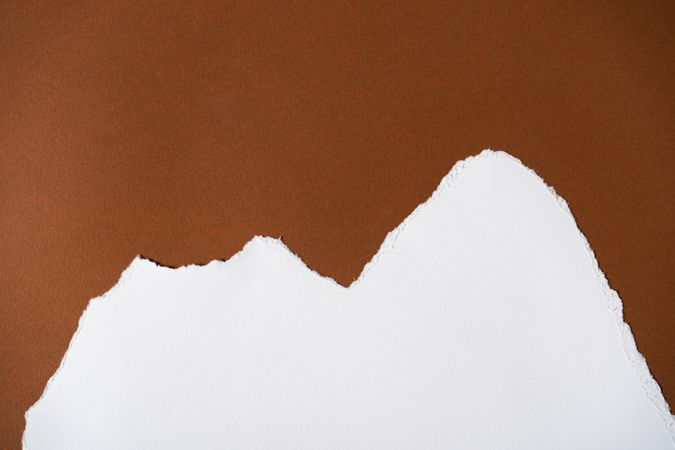 Earthy brown and light torn paper background