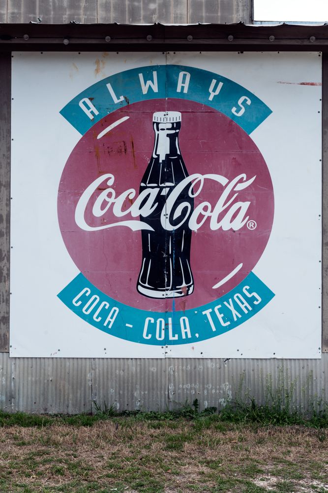 Old Coca-Cola sign on a building in Pipe Creek, a small community in Bandera County, Texas