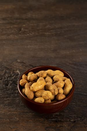 Bowl full of roasted peanuts.