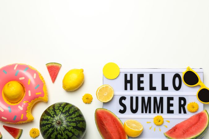 Sign hello summer with fresh fruits and glasses