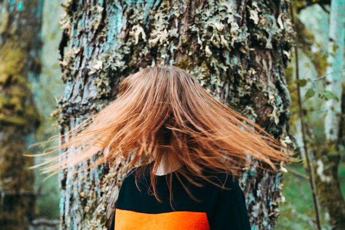 Casual redhead woman shaking with hair