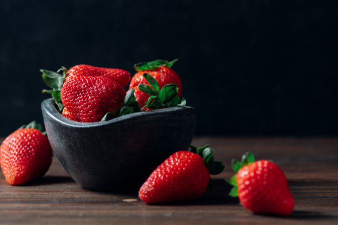 Fresh ripe strawberries in concrete bowl