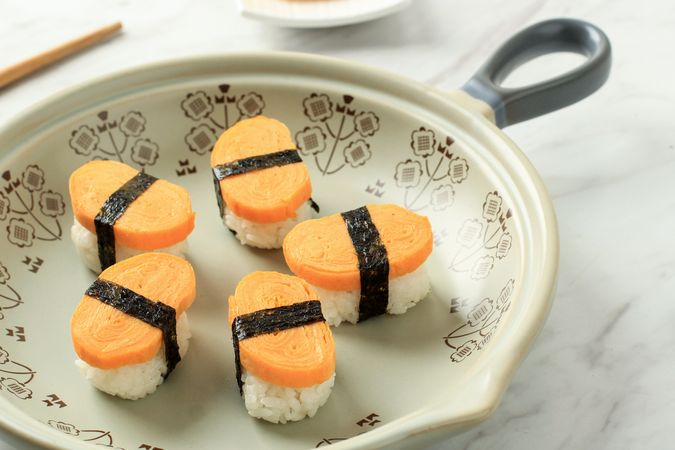 Plate of tamago, Japanese egg sushi on plate with space for text