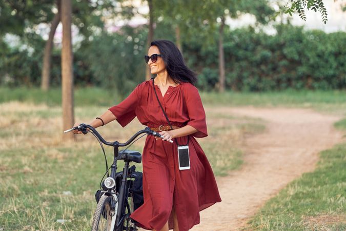Young woman with bicycle in park