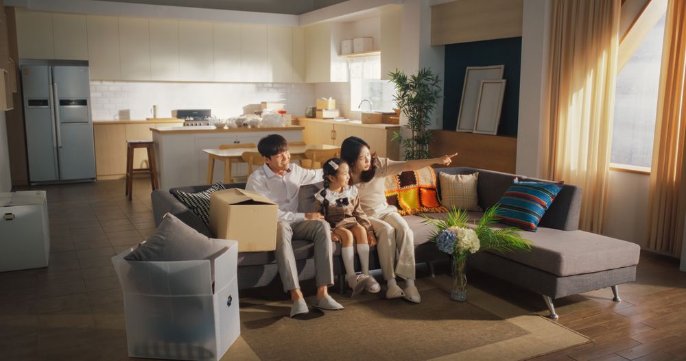 Family Moving in: Happy Young Korean Couple and Their Kid Sitting in Their Newly Purchased Apartment.