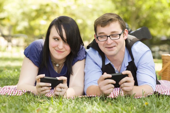 Young Couple at Park Texting Together
