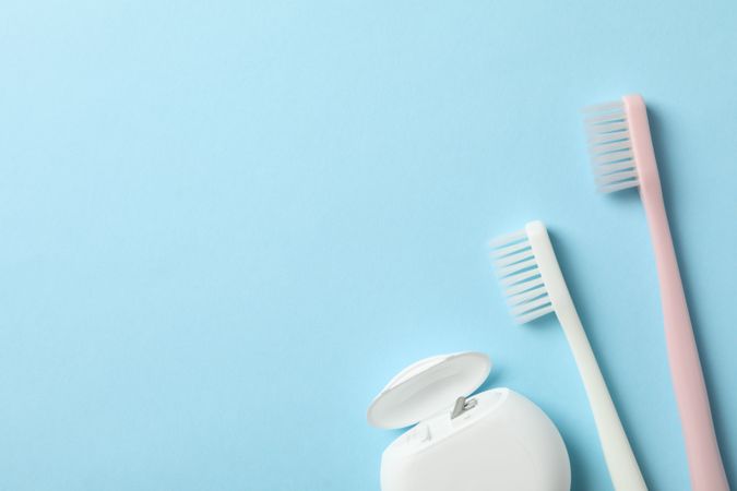 Tools for dental care on blue background, space for text