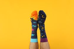 Casual clothes and wearing concept - socks, clothes for foot