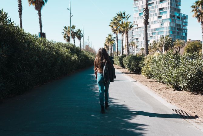 Teen girl walking happily through the streets.