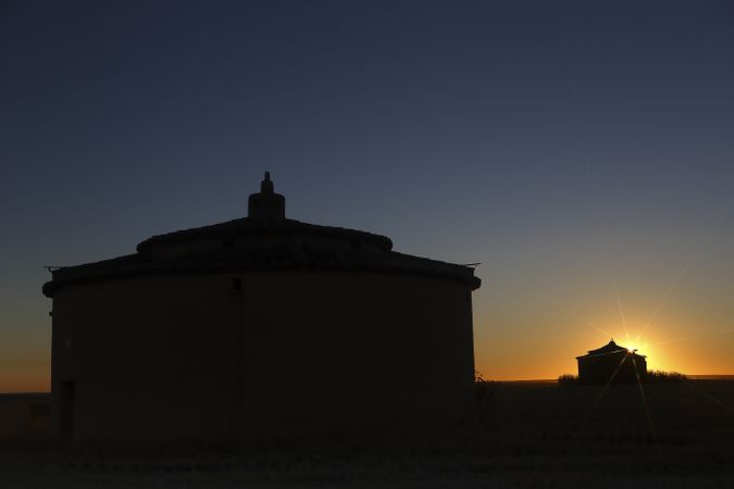 Aged house in rural countryside under starry sky
