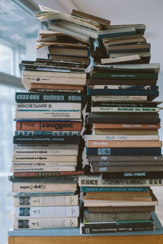 A lot of books stacked on table