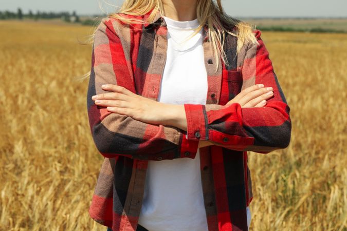Young woman in barley field. Agriculture business