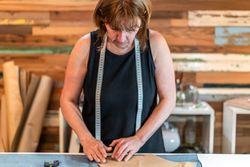 Seamstress working on fashion studio.  Designing clothing profession.