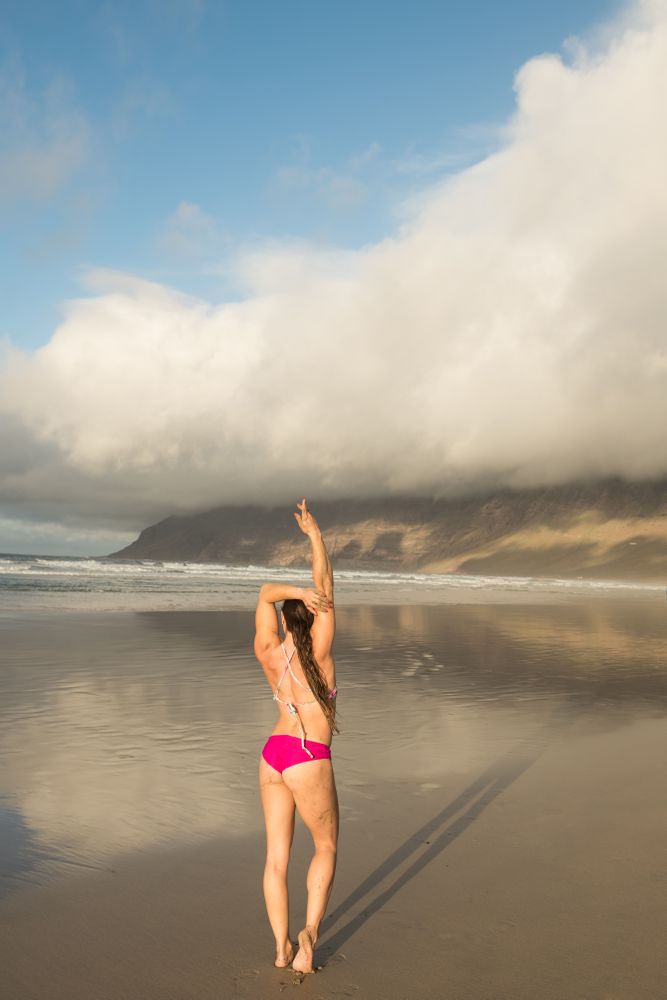 Woman stretching near sea
