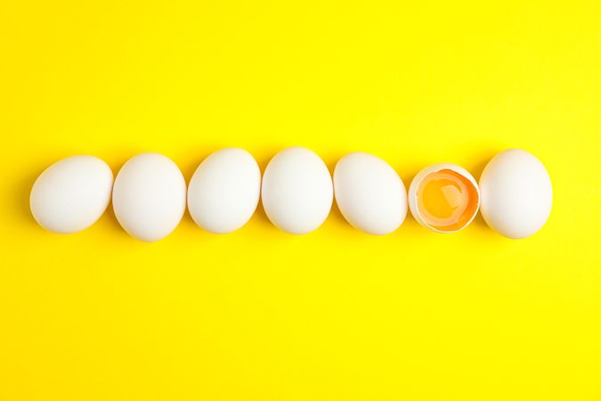 Flat lay composition with chicken eggs on color background, space for text