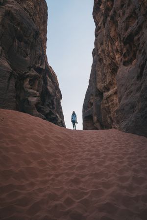 Unrecognizable woman in sandy ravine