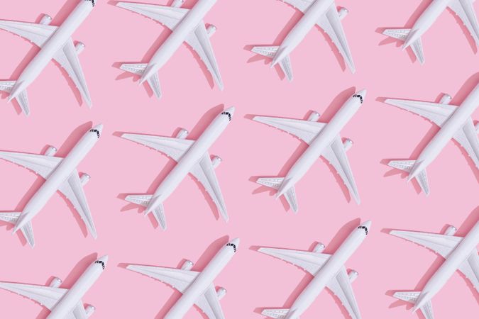 Passenger plane pattern on pastel pink background