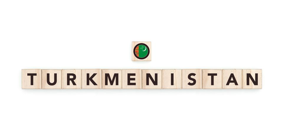 Wooden blocks bearing the name and flag of Turkmenistan. Turkmenistani and Asian Culture, national identity, travel, and geography in a copy space design.