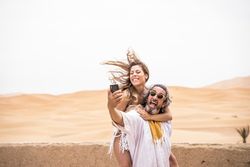 Laughing couple taking selfie on exotic terrace