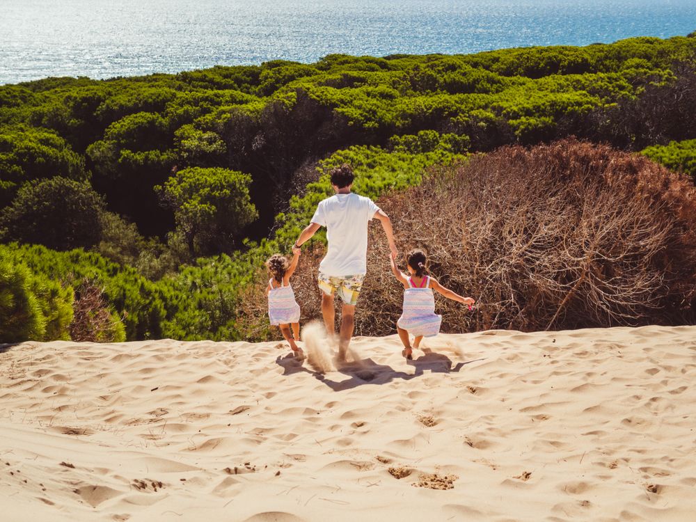 Anonymous family walking in the beach