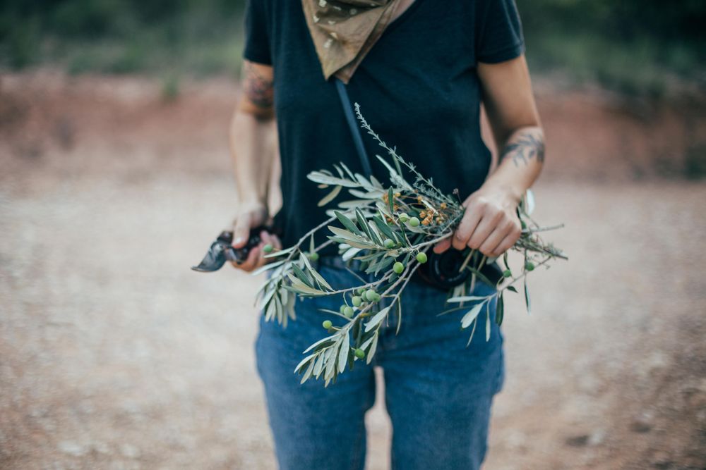 Woman in t-shirt holding olive branches