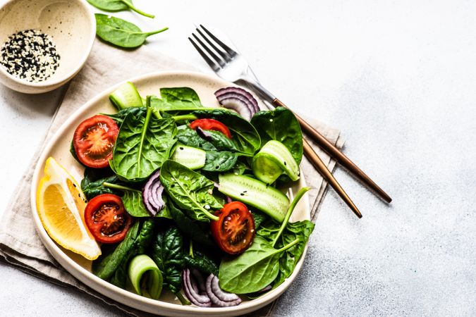 Leafy spinach salad with lemon slice