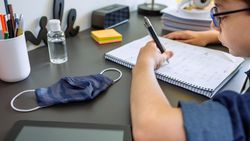 Teenager doing homework in his room