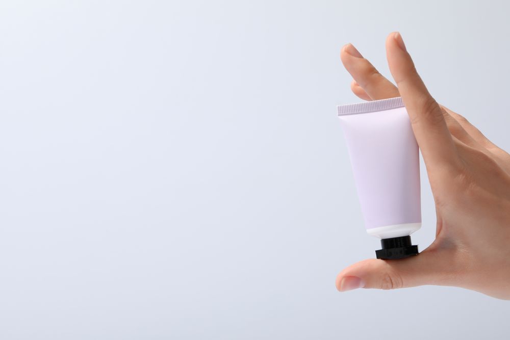 A jar of hand cream on a light background.