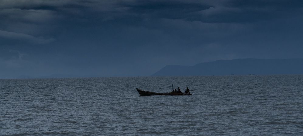 Sailing boat in dark sea