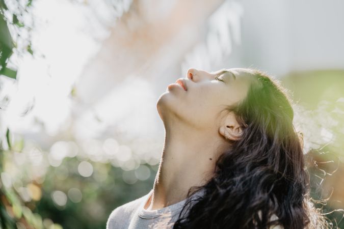 Cheerful woman smiling in garden