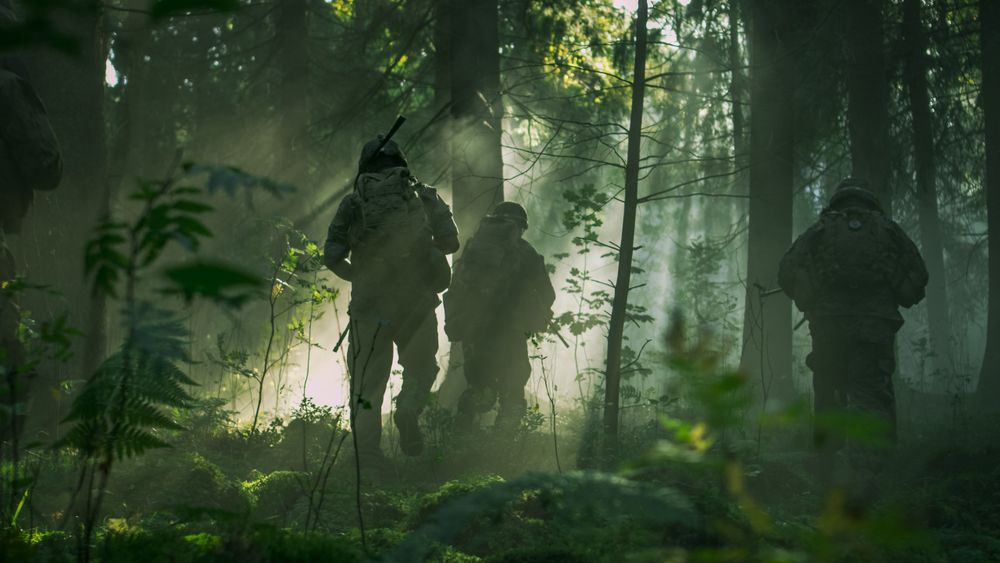 Fully Equipped Soldiers Wearing Camouflage Uniform Attacking Enemy, Rifles Ready to Shoot.