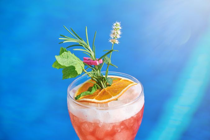 Glass of cocktail with mint and citrus slice