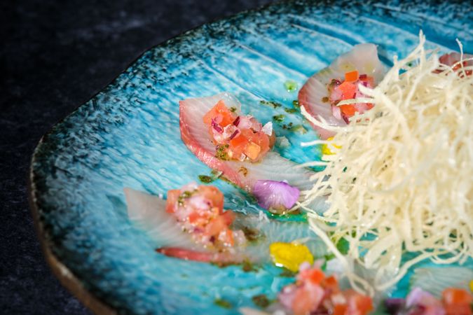 Part of blue plate with tasty Asian appetizer