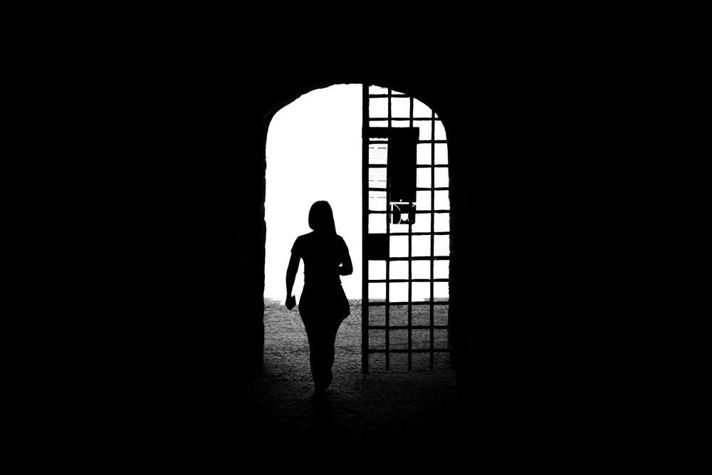 Woman walking through arch in Rome