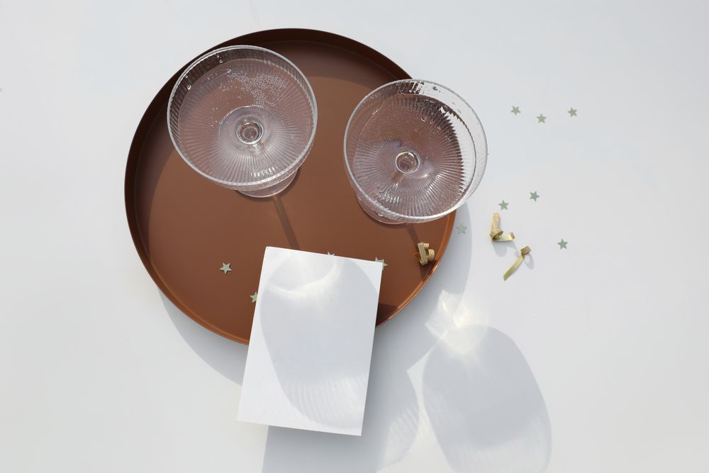 Bubbly wine glasses on round tray with mock up card