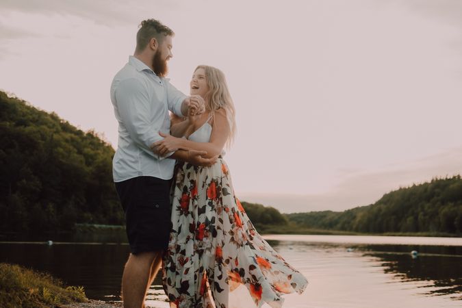 Loving couple standing ankle deep in water on beach