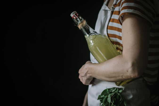 Female with bottle of elderflower syrup