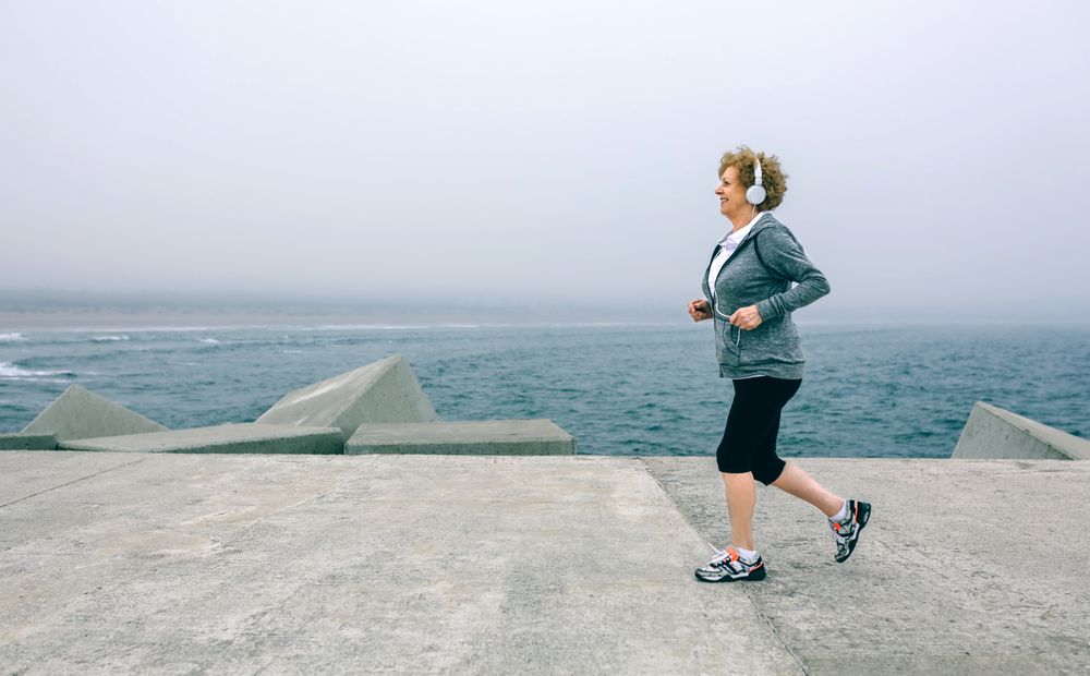 Older woman with headphones running