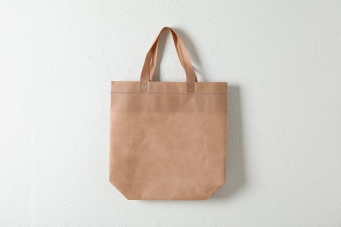 Tote cotton bag on neutral background, space for text