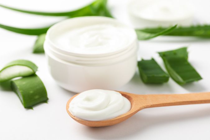 Composition with natural treatment accessories on light background, space for text. Aloe vera