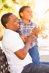 Portrait of Smiling Son and Father Outdoors Together.