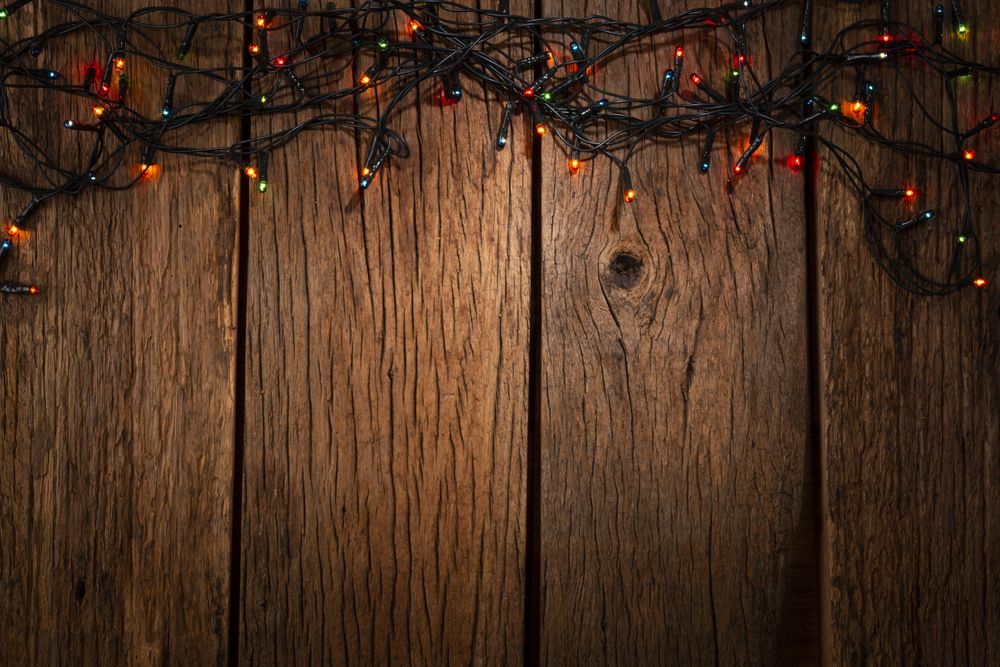 Wooden background with Christmas lights.