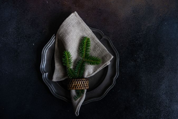Holiday table setting with fir in napkin