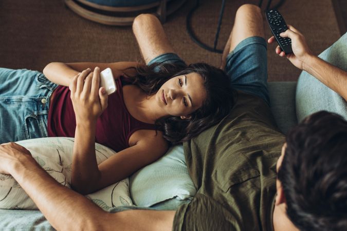 Couple relaxing in sofa in front of the TV