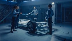 Automobile Engineers Working on Electric Car Platform Chassis, Using Tablet Computers