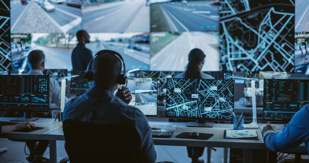 Diverse Team of Specialists Analyze Surveillance Feeds, Monitor Targets on a GPS City Map